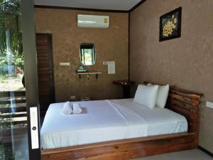 a bedroom with a bed with towels on it at Khao Sok Residence Resort in Khao Sok National Park