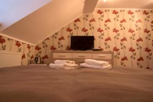 A bed or beds in a room at Penzión Galéria