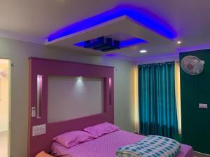 a bedroom with a purple bed and a mirror at Kandamath Heritage Resort in Kolattupuzha