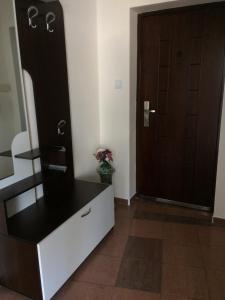 a room with a dresser with a mirror and a door at Апартамент Мони in Burgas City