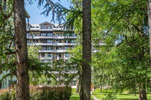 an apartment building seen through the trees at Résidence Pierre & Vacances Le Chamois Blanc in Chamonix +11 photos