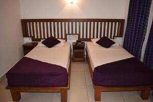 A bed or beds in a room at Port View City Hotel