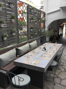 a long table with chairs and plants on a patio at Hotel Sweet Home in Neos Marmaras