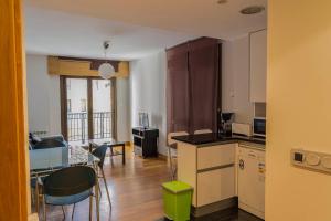 a kitchen and living room with a table and chairs at Real Unión by Basquelidays in Irún