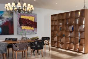 a dining room with a wooden table and chairs at Kassandra Bay Resort, Suites & Spa in Vassilias