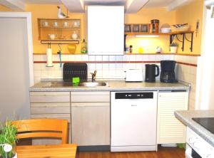 a kitchen with a sink and a white dishwasher at Fewo Holms in Winterberg