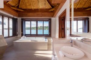 a bathroom with a large tub and a large window at Royalton Antigua, An Autograph Collection All-Inclusive Resort & Casino in Five Islands Village