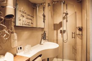 a bathroom with a sink and a shower at Landgasthof Zehner in Drosendorf