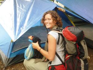 a woman with a backpack sitting in a tent at La Casita de Don Daniel in Valle de Anton