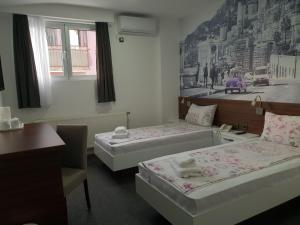 Postel nebo postele na pokoji v ubytování Garni Hotel Niš City View