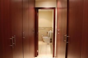 
a bathroom with a mirror and a toilet at California Hostel Dubai Beach in Dubai
