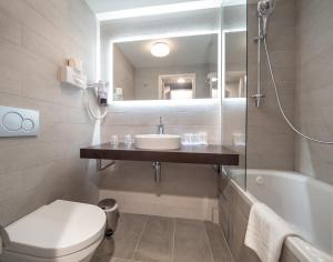 a bathroom with a sink and a toilet and a mirror at Hotel Best Western City Centre in Brussels