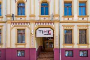 a building with a sign that reads time lapse at Penzión TIME in Prešov