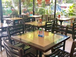 a group of tables and chairs in a restaurant at My Dream Place Hotel - Near Robinsons Mall in Butuan