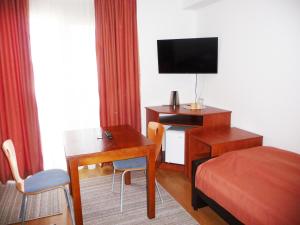 TV i/ili multimedijalni sistem u objektu Sobe Rooms Aleksandar