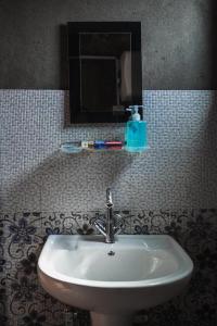 a white sink in a bathroom with a mirror at Beautiful View Homestay in Darjeeling