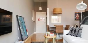 een woonkamer met een witte bank en een tafel bij Toctoc Studio in Porto