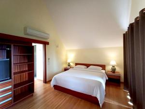 a bedroom with a large bed and a television at Blue Chill private Pool Villa - Koh Chang in Ko Chang