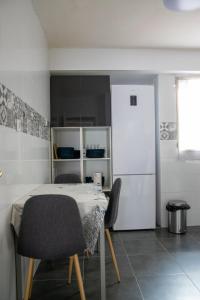 a room with a table and two chairs and a refrigerator at Casaelcandano in Mieres +8 photos