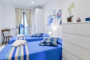 two beds in a room with blue and white at Il Profumo di Capri in Massa Lubrense