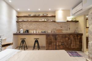a kitchen with a counter and two stools at Lemon Garden Residence in Heraklio Town +73 photos