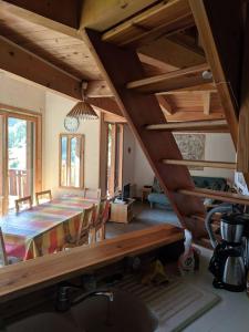 a kitchen and dining room with a table and a clock at Les Cristallieres Venosc in Vénosc