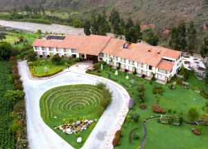 an aerial view of a large house with a garden at Taypikala Deluxe Valle Sagrado in Urubamba