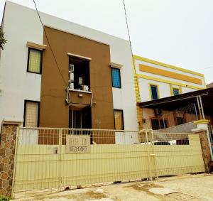 a yellow fence in front of a house at Delta Inn Bogor Syariah for Indonesian Only in Bogor