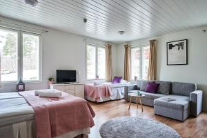 a living room with a bed and a couch at Guest House Porvoo in Porvoo