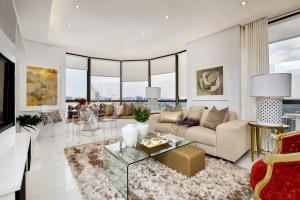a living room with a couch and a table at Sandton Skye Premium Suites & Penthouses in Johannesburg