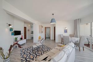 a living room with a couch and a table at Alegria I by An Island Apart in Funchal