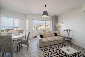 a living room with a couch and a table at Alegria I by An Island Apart in Funchal