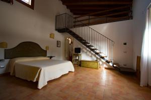 a bedroom with a bed and a staircase at Maragani Beach in Maragani