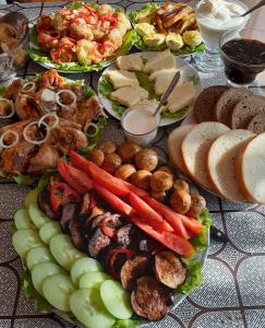 a table topped with lots of different types of food at Apartments on Akhalubani St 2 in Tbilisi City