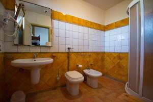 a bathroom with a sink and a toilet and a mirror at Maragani Beach in Maragani +17 photos