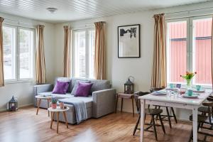 a living room with a couch and a table at Guest House Porvoo in Porvoo