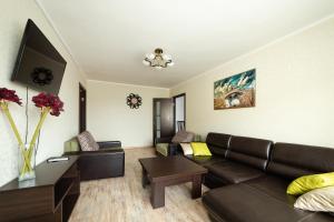 a living room with a couch and a table at Apartment in the city center in Baranavichy