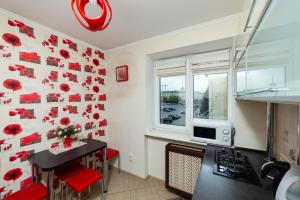 a kitchen with red poppies on the wall at Apartment in the city center in Baranavichy