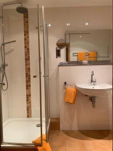 a bathroom with a shower and a sink at Hotel Sonnenhof in Boppard