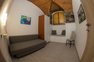a room with a couch and a window and a chair at 5 terre e dintorni Rental House in La Spezia