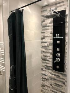 a shower with a black shower curtain in a bathroom at Spacious modern vintage flat in the heart of Sofia in Sofia