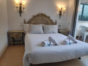 a bedroom with a white bed with two pillows on it at SUITEDREAMS - Pollancre 61 in Andorra la Vella