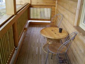 a porch with a table and chairs on a balcony at Family Home in Fáskrúðsfjörður