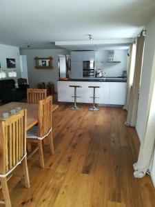 a dining room and living room with a table and chairs at Casa Basilea in Valbella