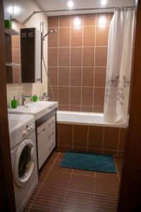 a bathroom with a sink and a washing machine at Квартира Люкс in Vinnytsya +21 photos