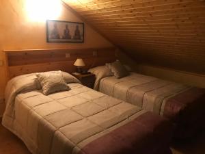 מיטה או מיטות בחדר ב-Hotel Rural Grado del Pico