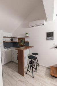 a kitchen with a counter and stools in it at Apart 31 in Cetinje