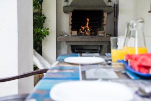 a table with a fire place in the background at Hauzify I Villa Parc in Hospitalet de l'Infant
