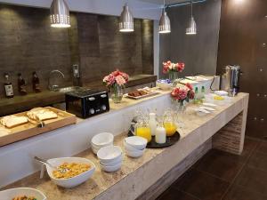 a buffet with food and drinks on a counter at Lib Hotel Bellavista in Santiago