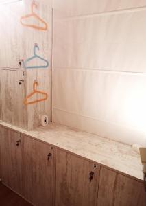 a bathroom counter with two hangers on the wall at PIJAMA HOUSE in Plovdiv